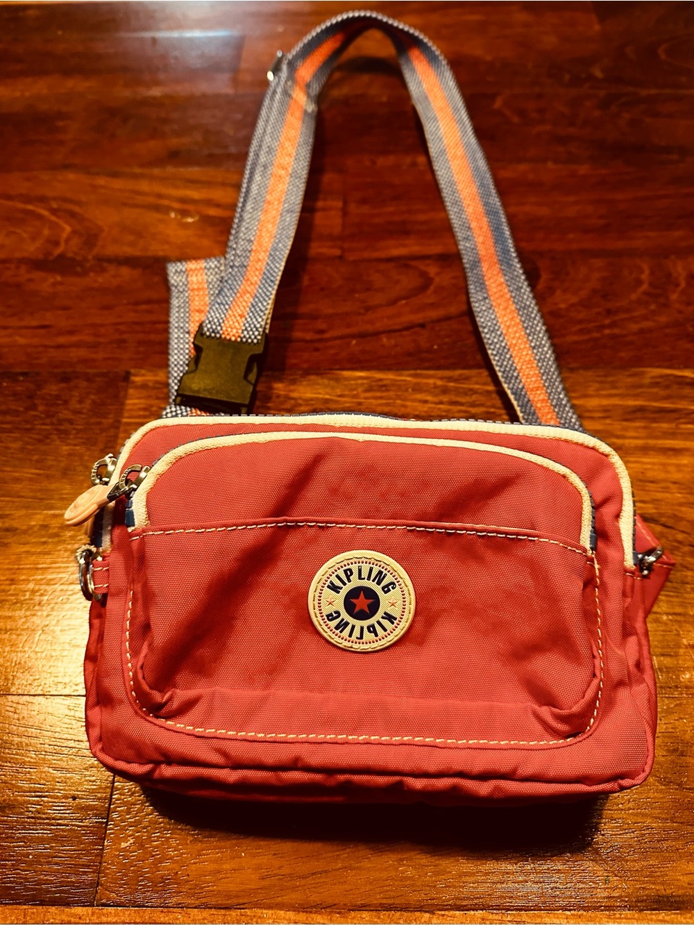 Kipling Coral-Red Crossbody Belt Bag with Striped Strap